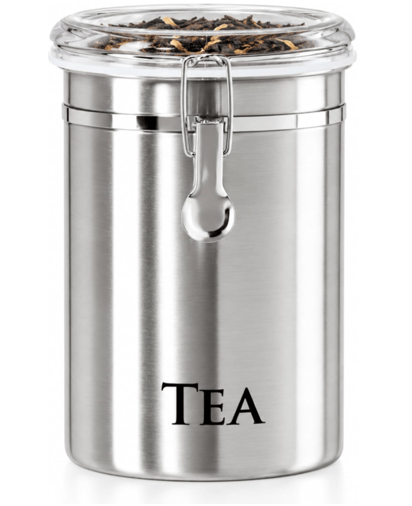 A silver metal tea canister with a glass lid and a clamp closure, filled with loose tea leaves.