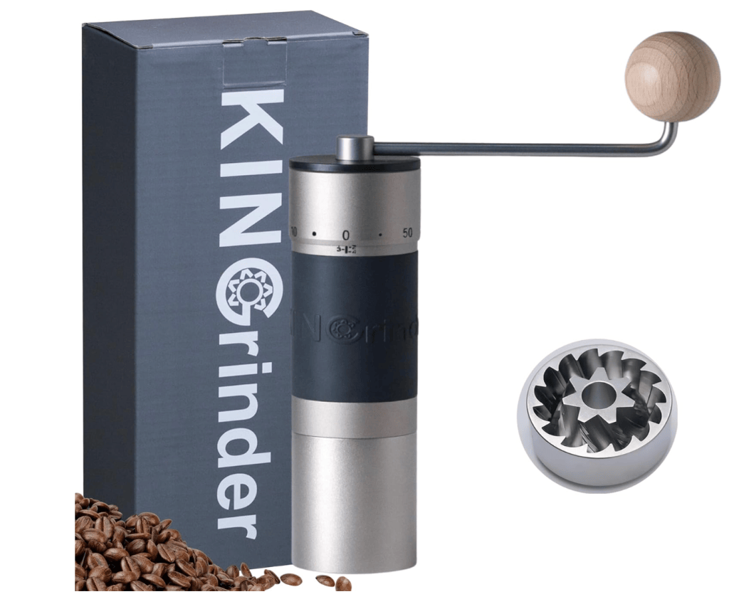A manual coffee grinder with a wooden handle, displayed next to coffee beans and its packaging, showcasing the grinder's design and metal burr.