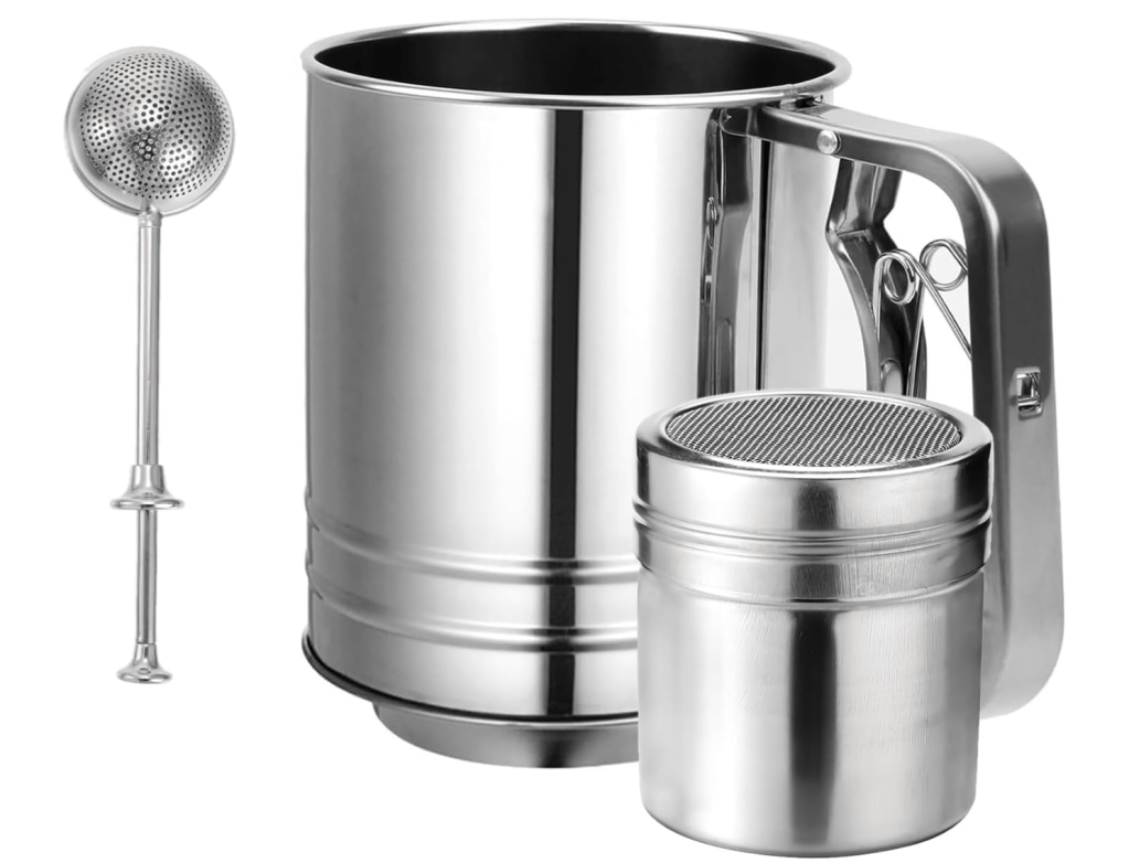 A stainless steel flour sifter with a handle, a small storage container with a mesh lid, and a metal strainer are displayed together.